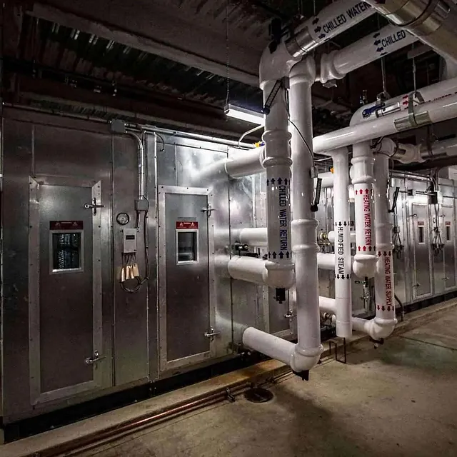 Large room with pipes and valves in New Construction Project at Midwest Medical Facility, Chicago