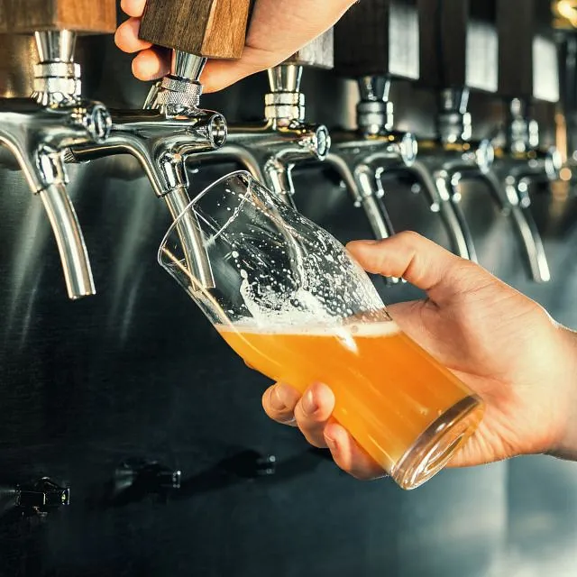 A man filling a glass of beer at a pub in Chicago, IL