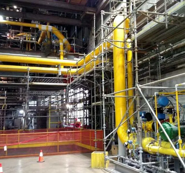 Industrial building, featuring yellow pipes, part of a natural gas conversion station in Chicago, IL