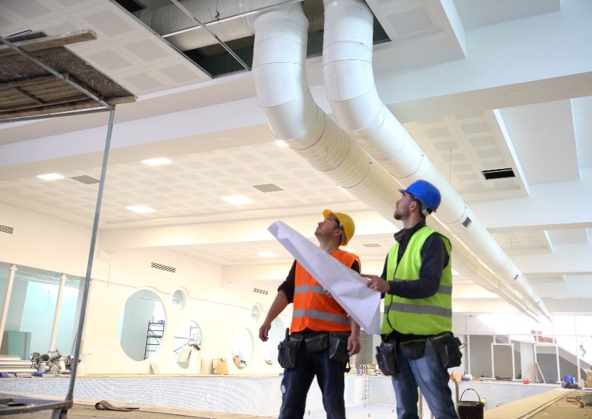 Hayes Mechanical professional's inspecting a HVAC system in Chicago, IL